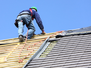 a roofing technician installing a new roof on a home