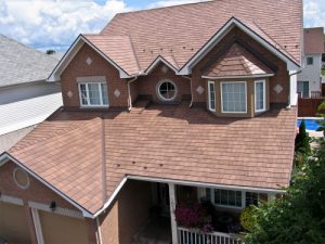 an asphalt shingle roof on large family home
